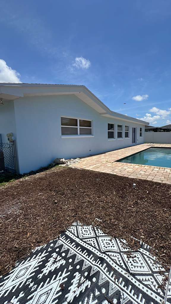 Poolside Stucco Repaint — Exterior Repainting project by JDC Painting in Belleair, FL